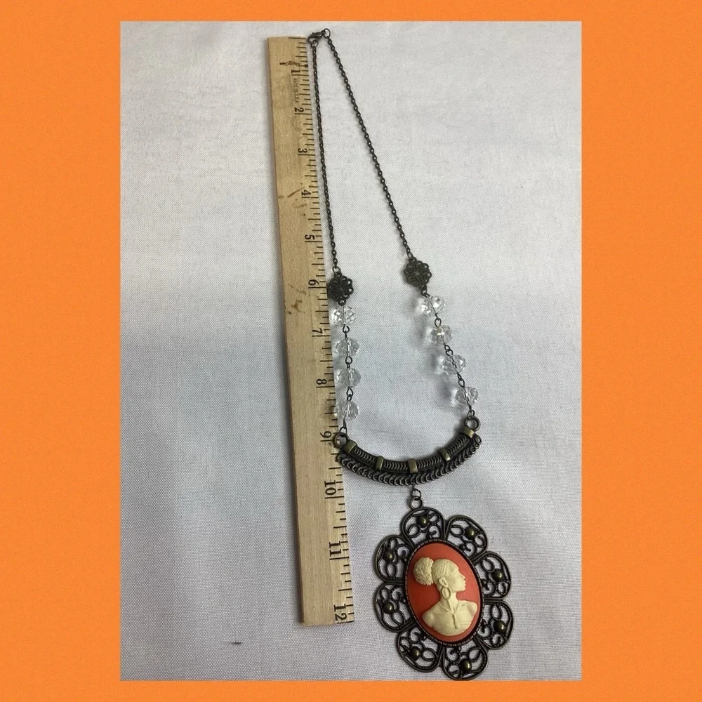 Orange and bronze cameo necklace.